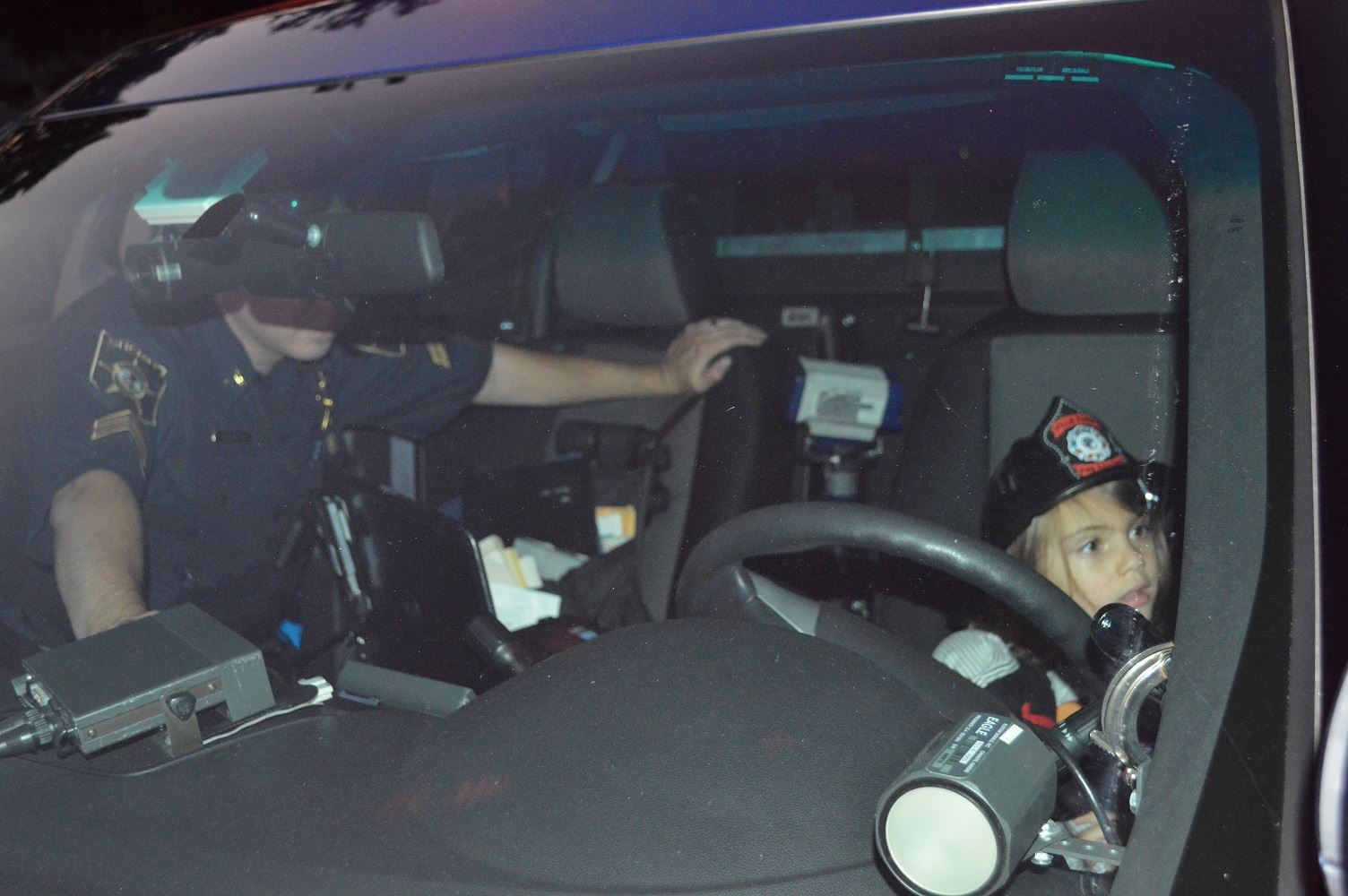 Children take turns checking out the view from the driver's seat of a DuPage County Sheriff's vehicle during a National Night Out event at the Iowa Community Center, Aug. 2.